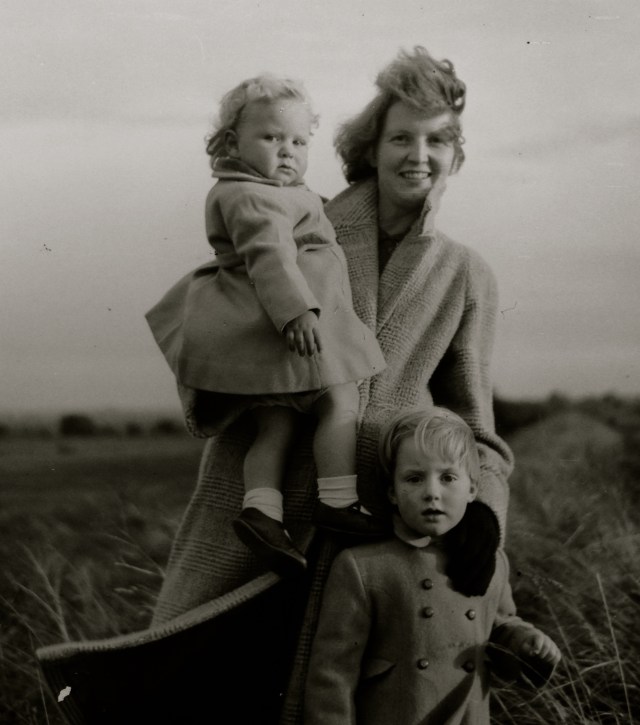 The author being held by her mother, and her sister, circa 1957